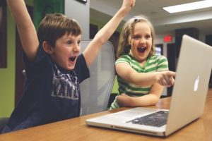 Enfants joyeux devant un écran de pc portable